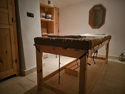 a bed sitting on top of a table in a room at Kasbah La Cigogne in Aït Ben Haddou