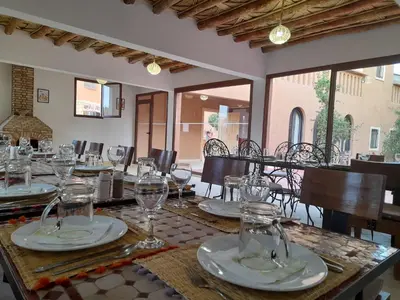a dining room with a table with glasses on it at Kasbah La Cigogne in Aït Ben Haddou