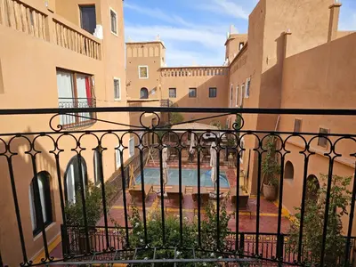 a view from the balcony of a building with a pool at Kasbah La Cigogne in Aït Ben Haddou