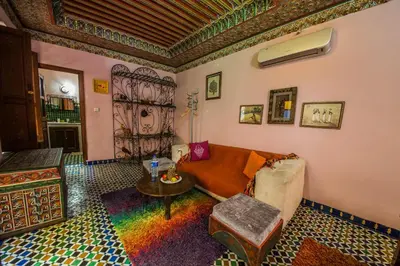 a living room with a couch and a table at Riad L'Artiste in Fès