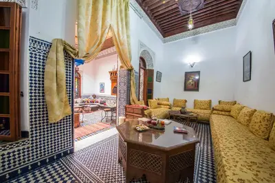 a living room with a couch and a table at Riad L'Artiste in Fès