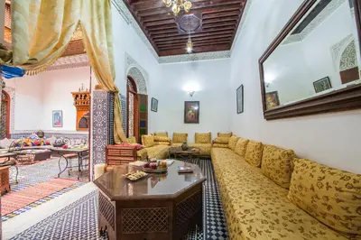 a living room with a couch and a table at Riad L'Artiste in Fès