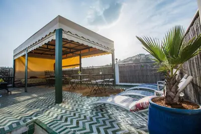 a patio with a gazebo and a table and chairs at Riad L'Artiste in Fès