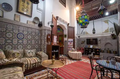 a living room with a couch and a table at Maison Famille Tazi in Fès