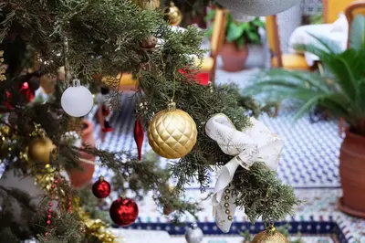 a christmas tree with christmas ornaments on it at Riad Alassala Fes in Fès