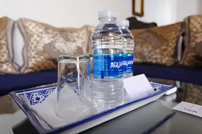 a bottle of water sitting on a tray on a table at Riad Alassala Fes in Fès