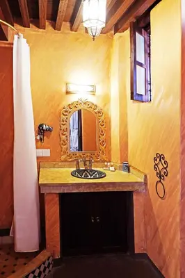 a bathroom with a sink and a mirror at Riad Alassala Fes in Fès
