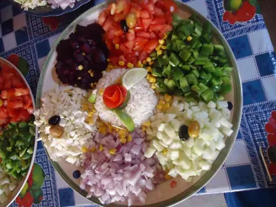 a plate of food with vegetables and rice on a table at Auberge L'Oasis in Foum Zguid