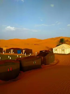 a group of tents in the sand in the desert at Auberge Camping Ocean des dunes in Merzouga
