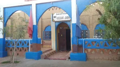 a small blue and white building with a door at Auberge Camping Ocean des dunes in Merzouga