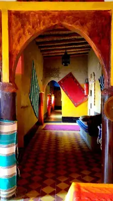 a room with an archway in a building at Auberge Camping Ocean des dunes in Merzouga