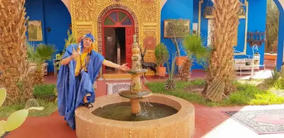 a statue of a man standing next to a fountain at Riad Jasmine Sud in Zagora