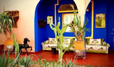 a blue room with couches and potted plants at Riad Jasmine Sud in Zagora