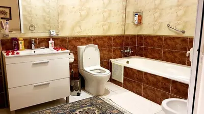 a bathroom with a toilet and a tub and a sink at Riad Jasmine Sud in Zagora