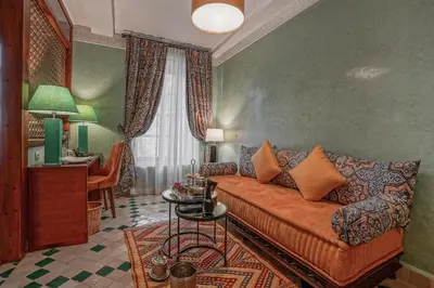 a living room with a couch and a table at Algilà Fes Riad Medina Charme Hotel in Fès