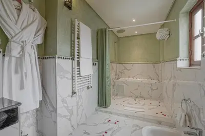 a bathroom with a shower and a sink and a tub at Algilà Fes Riad Medina Charme Hotel in Fès