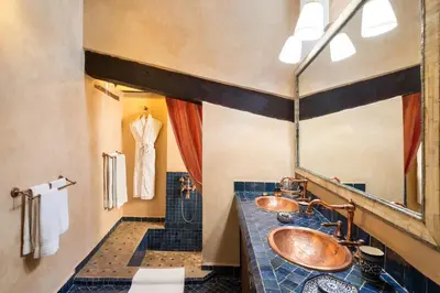 a bathroom with two sinks and a mirror at Algilà Fes Riad Medina Charme Hotel in Fès