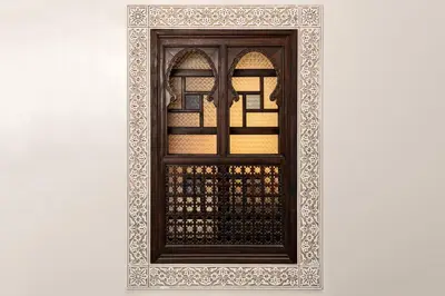 a window with a wooden frame on a white wall at Algilà Fes Riad Medina Charme Hotel in Fès