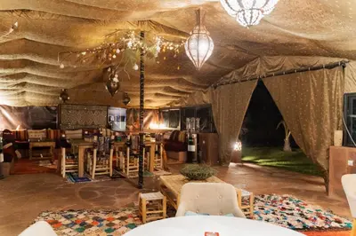 a tent with tables and chairs in a room at Les Jardins de Taja in Ourika