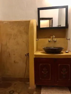 a bathroom with a sink and a mirror at Les Jardins de Taja in Ourika