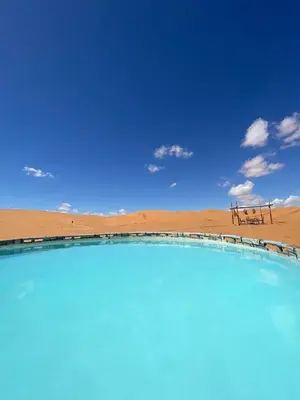 a swimming pool in the middle of a desert at Sahara Majestic Luxury Camp in Merzouga
