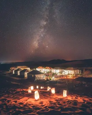 a starry night with a group of tents in the desert at Sahara Majestic Luxury Camp in Merzouga