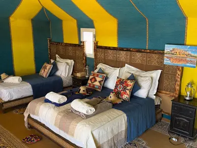 a bedroom with two beds with stuffed animals on them at Sahara Majestic Luxury Camp in Merzouga
