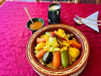 a bowl of food sitting on a red table at Dar Isselday in Tisselday