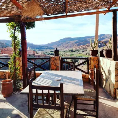 a table and chairs on a patio with a view at Dar Isselday in Tisselday