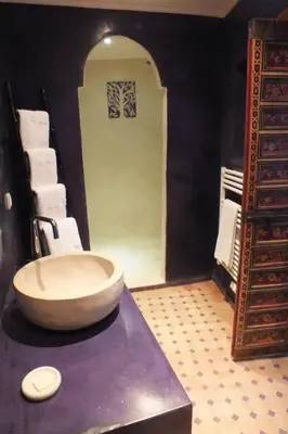 a bathroom with a large bowl sink on a counter at Dar Faracha Fes in Fès