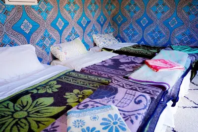 two beds sitting next to each other in a room at Mustapha Camp Merzouga in Merzouga