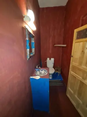 a bathroom with a sink and a toilet in a room at Riad Tigmi du Soleil in Aït Ben Haddou