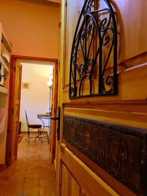 a door to a room with a table and a chair at Kasbah Ait ben Damiette in Skoura