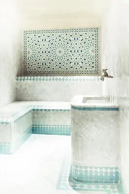 a bathroom with blue and white tiles and a sink at Chaq Chaq in Fès