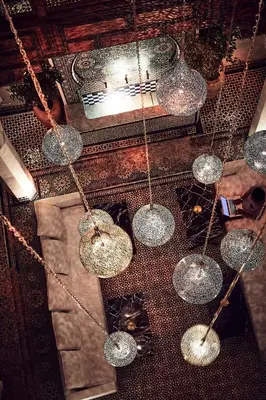 a group of glass spheres hanging from a ceiling at Chaq Chaq in Fès