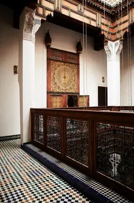 a large wooden door in a room with a tiled floor at Chaq Chaq in Fès