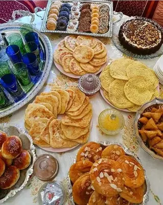 a table topped with lots of different types of pastries at Ryad Bab Berdaine in Meknès