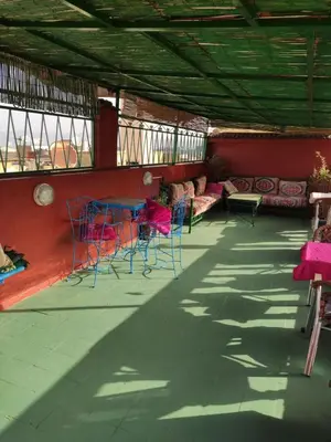 a room with chairs and tables and a couch at Ryad Bab Berdaine in Meknès