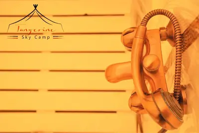 a telephone hanging on a wall next to a garage at Boho Glamping in Merzouga