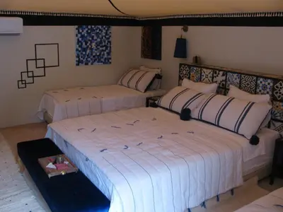 a bedroom with two beds in a room at Sahara Luxury Tents in Merzouga
