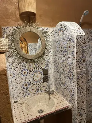 a bathroom with a mirror and a sink at Dar Nomads in Mhamid
