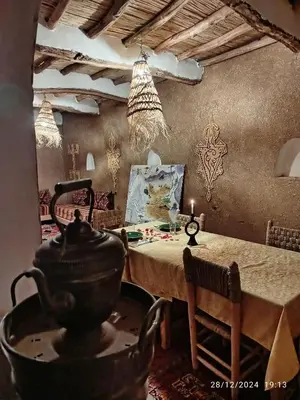 a dining room with a table with a pot on it at Dar Nomads in Mhamid