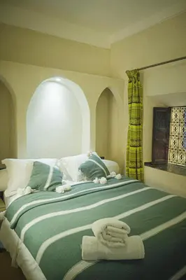 a bedroom with a bed with two towels on it at Auberge Ayam Atlas- pool 10mn away in Ourika