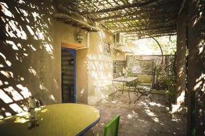 an outdoor patio with a table and chairs on a building at Auberge Ayam Atlas- pool 10mn away in Ourika