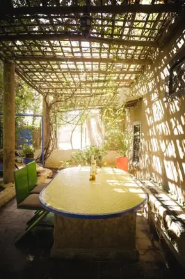 a patio with a table and chairs in a building at Auberge Ayam Atlas- pool 10mn away in Ourika