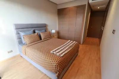 a bedroom with a large bed and a closet at Prestigia Fès in Fès