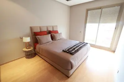 a bedroom with a large bed and a window at Prestigia Fès in Fès