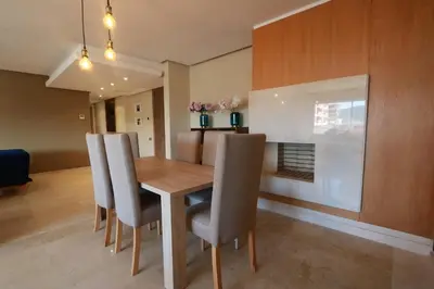 a dining room with a wooden table and chairs at Prestigia Fès in Fès