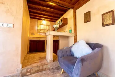 a living room with a couch and a fireplace at Dar Attajalli in Fès