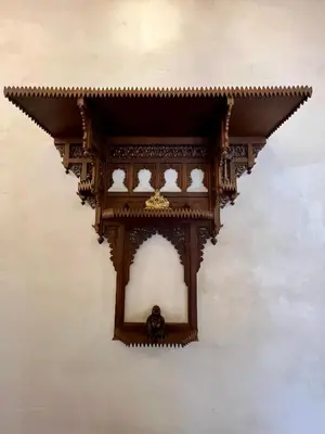 a clock on the side of a wall at Dar Attajalli in Fès